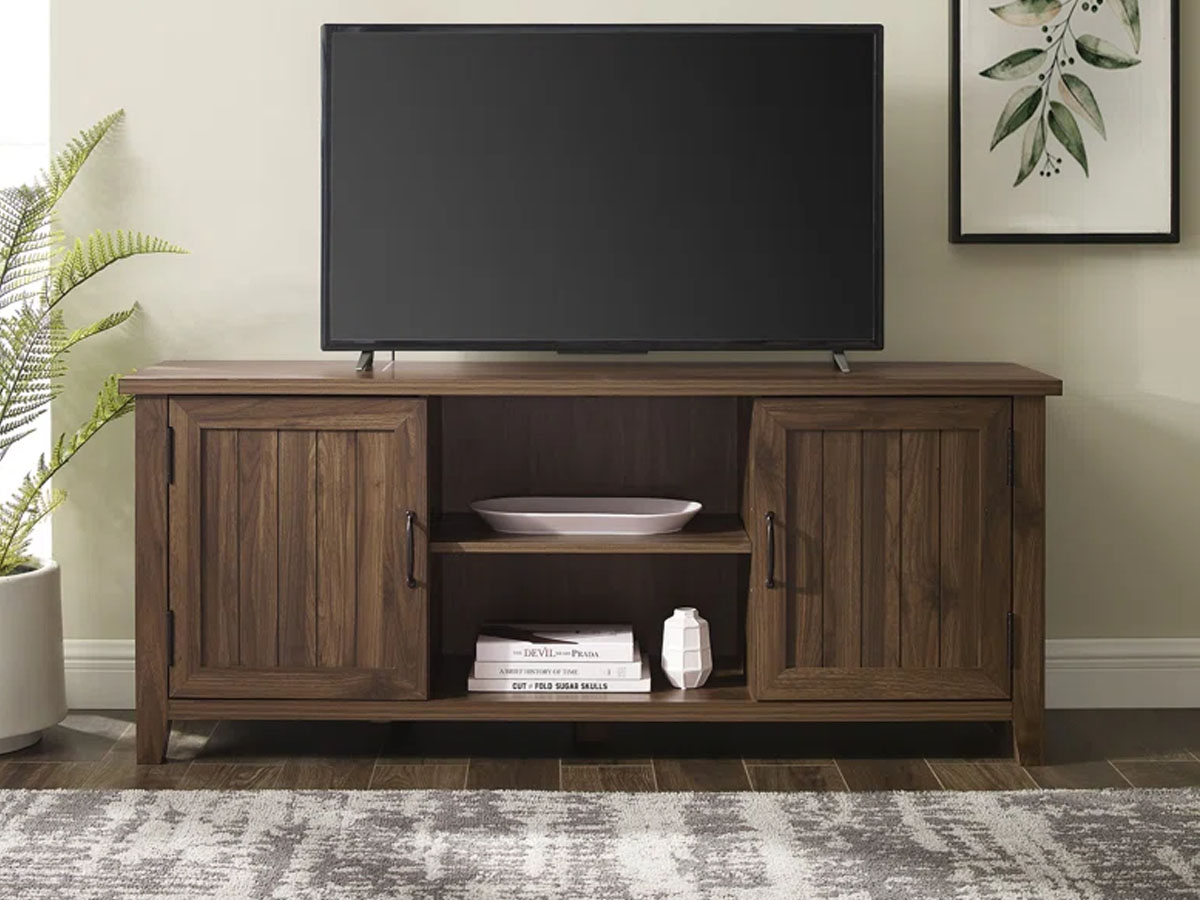 dark brown tv stand with tv sitting on it in living room