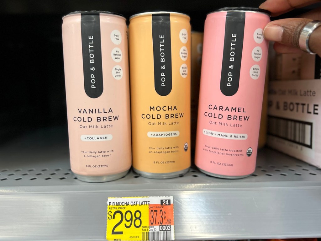 three pop & bottle latte cans on shelf in walmart