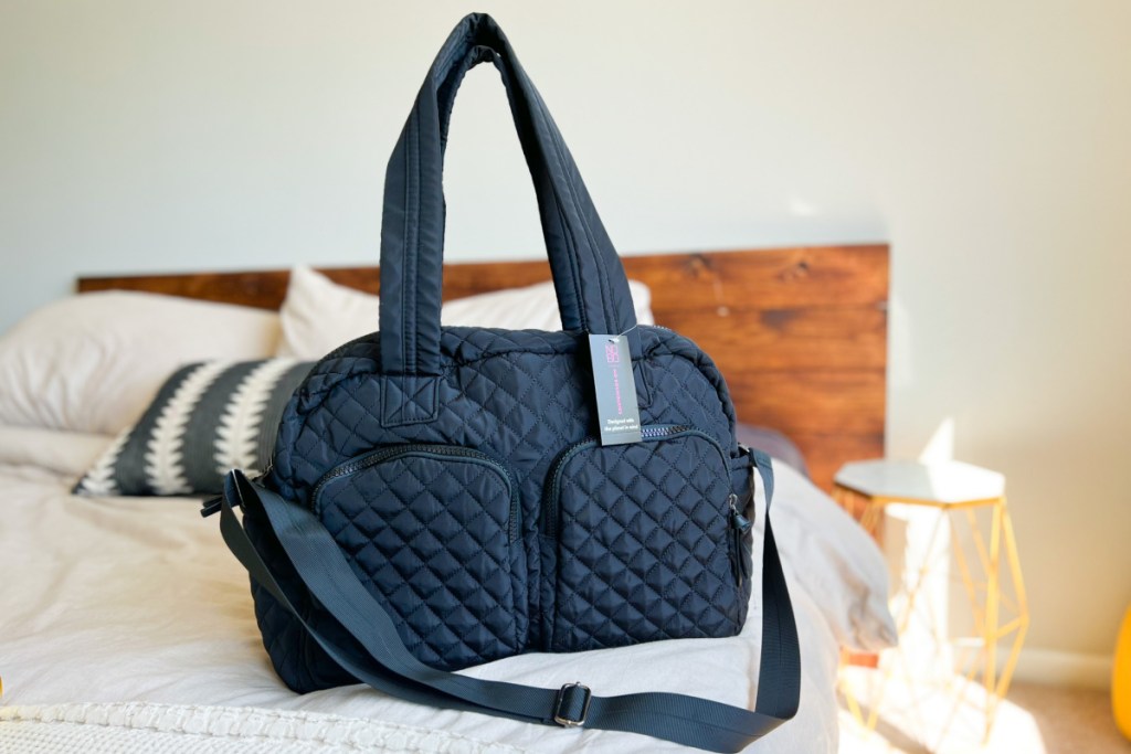 black quilted weekender bag on bed