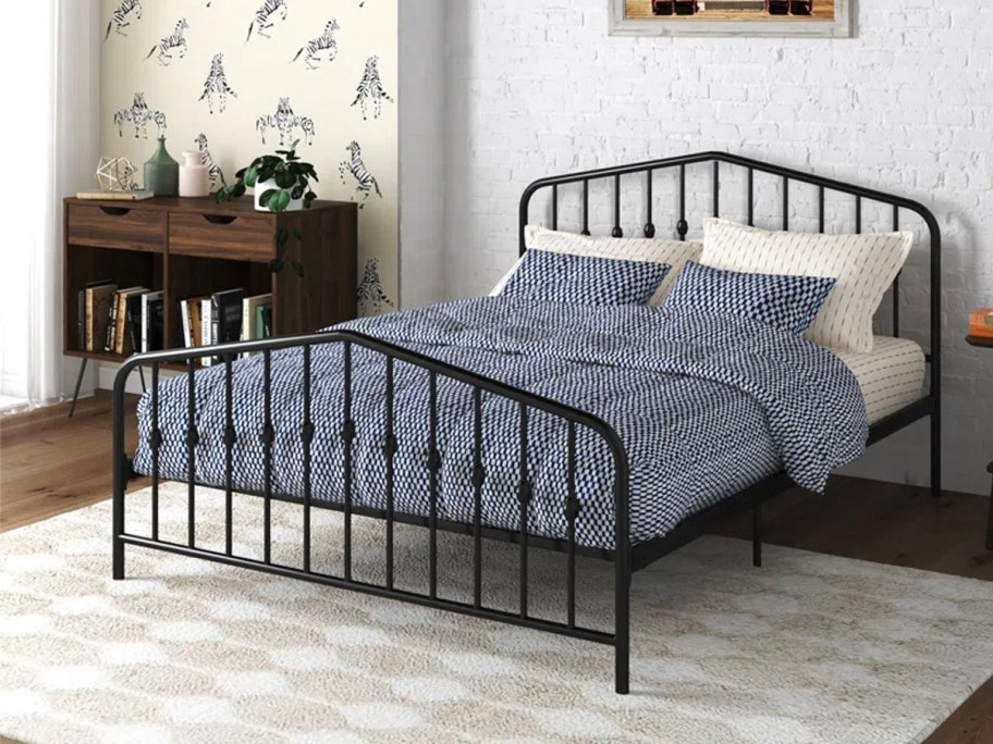 metal bed with blue onlineforter set on top