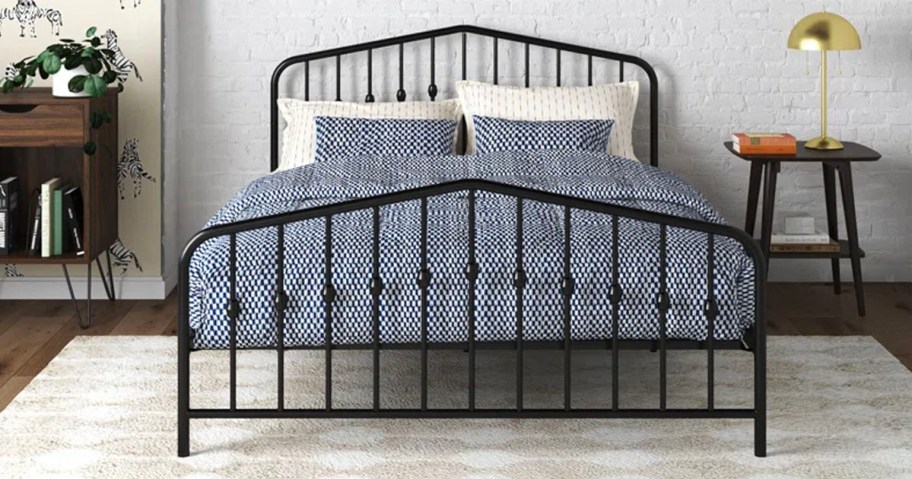 metal black bed with blue onlineforter set and white pillows 