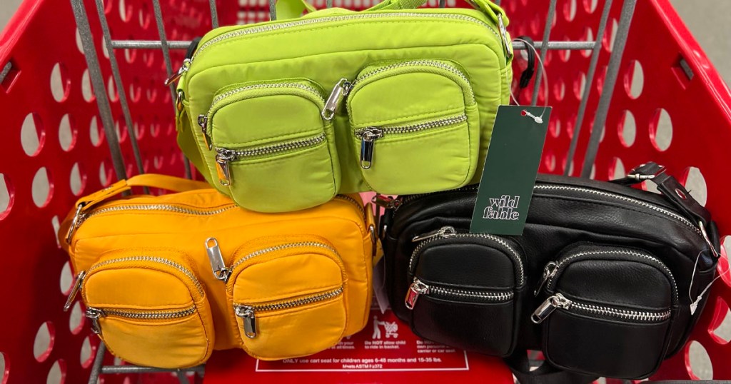 green, orange and black crossbody purses in target shopping cart