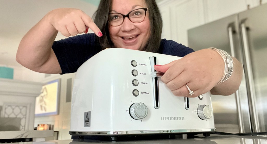 woman pointing to a redmond amazon toaster