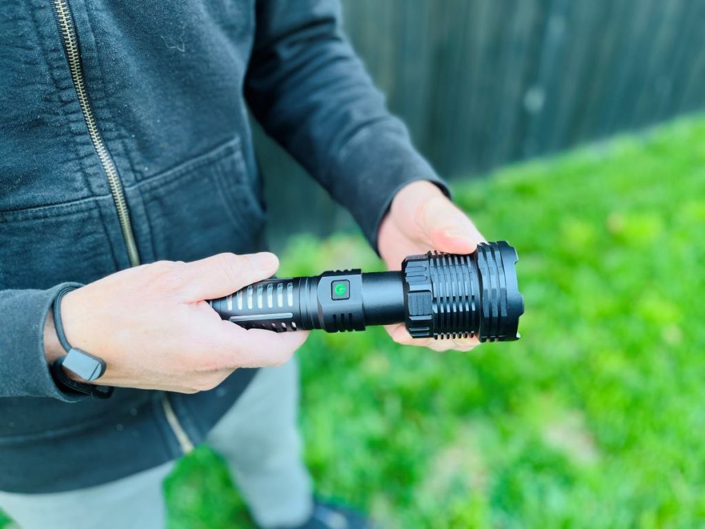 Hand holding a black flashlight