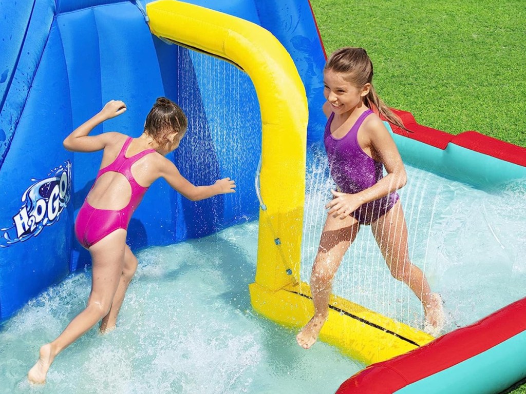 kids running through sprinklers and shallow pool 