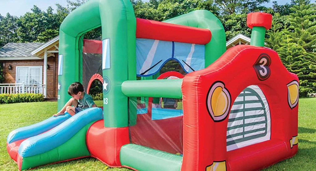 CocoNut Float Red & Red Big Rig Truck Bouncy Castle with child playing in it