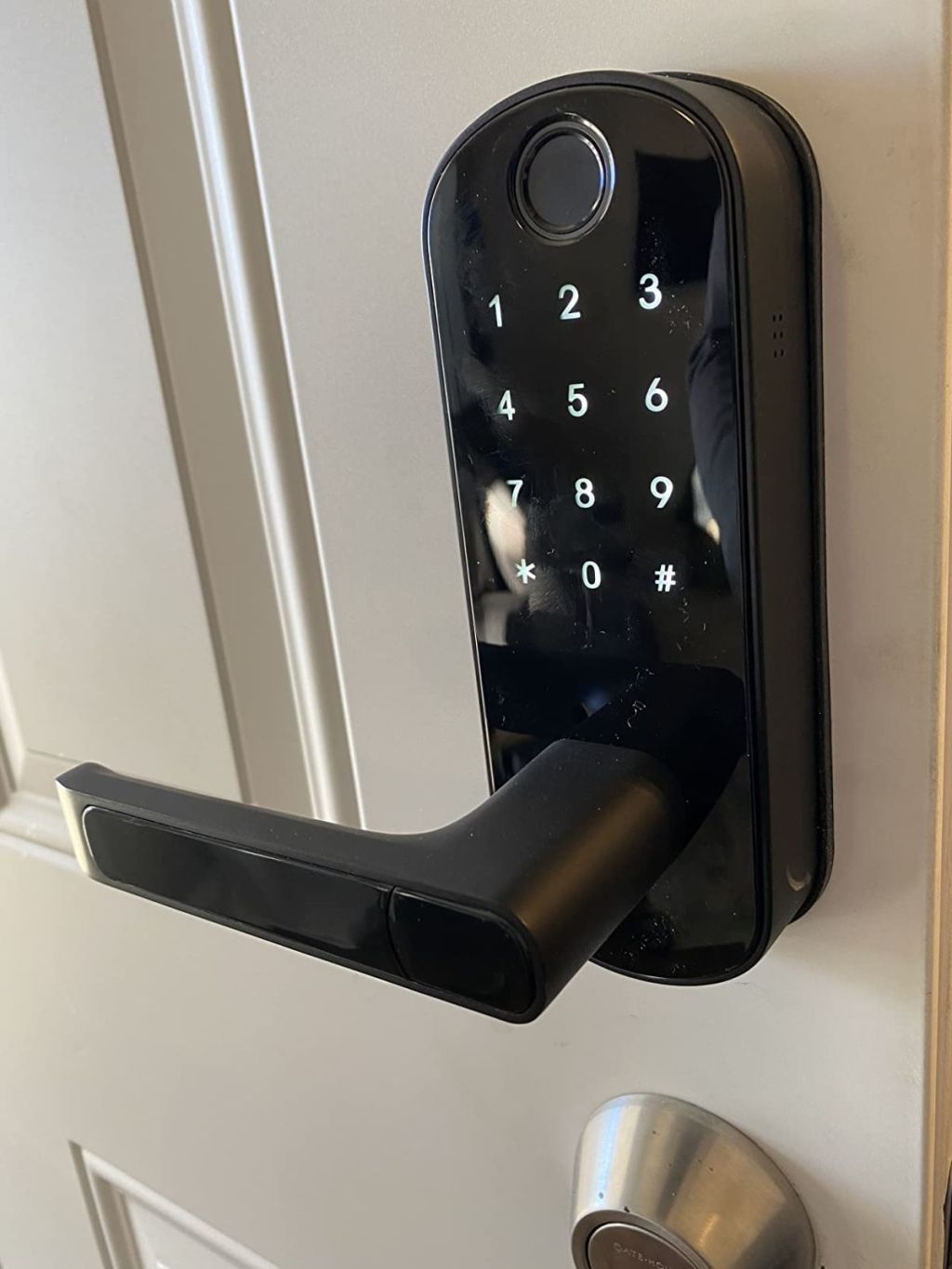 Black smart lock on a white door