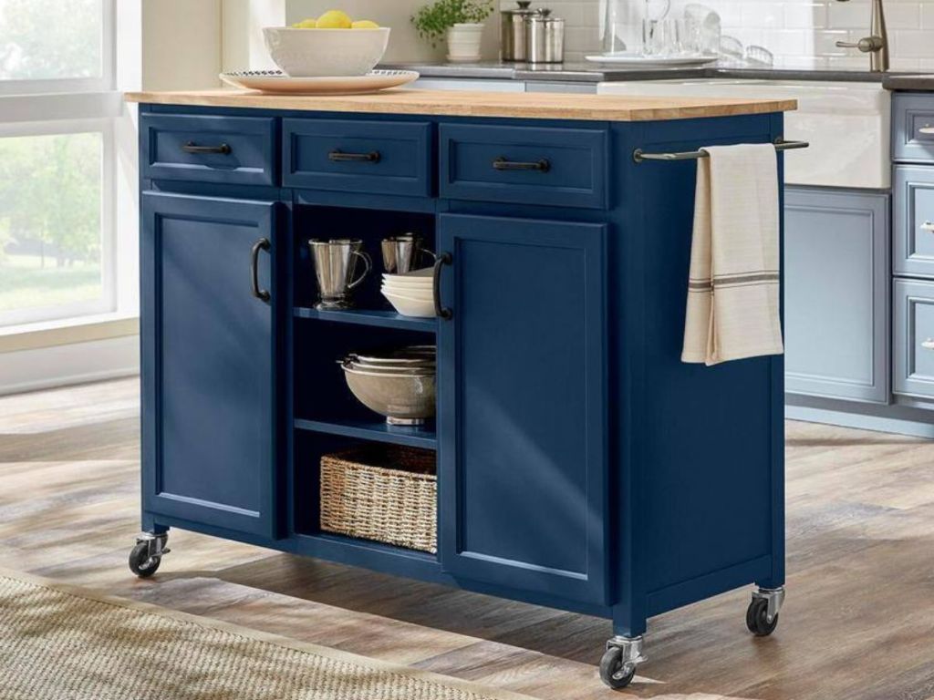 A dark blue rolling kitchen island