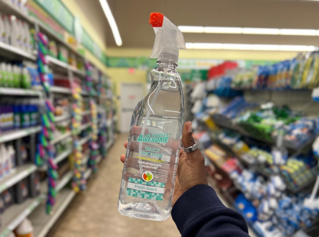 Woman holding a daily shower spray from dollar tree