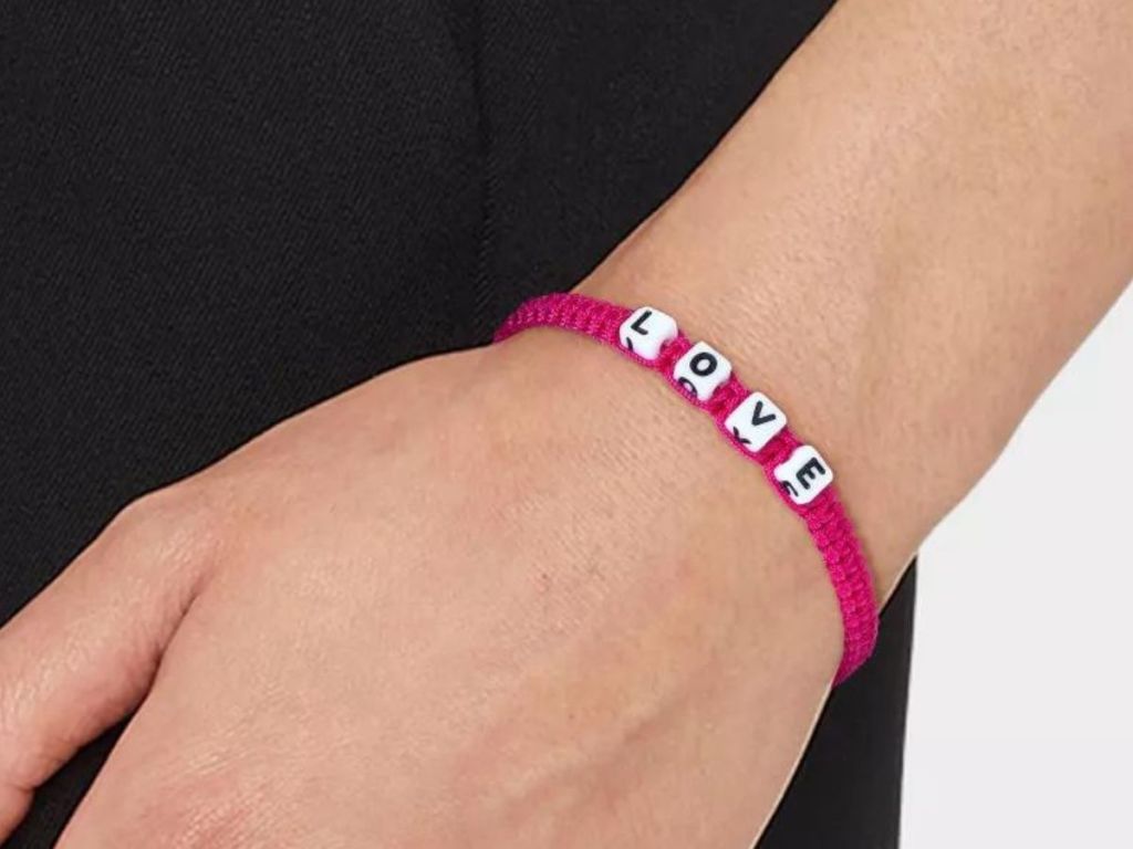 A woman wearing a Little Words Project Love Woven Bracelet