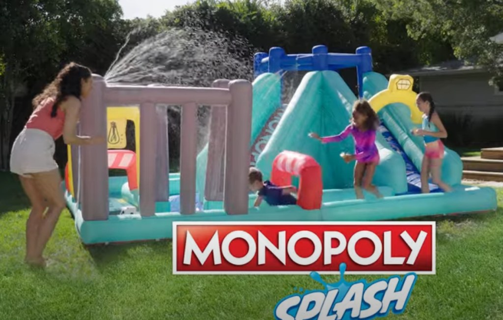 Kids playing on an inflatable water park