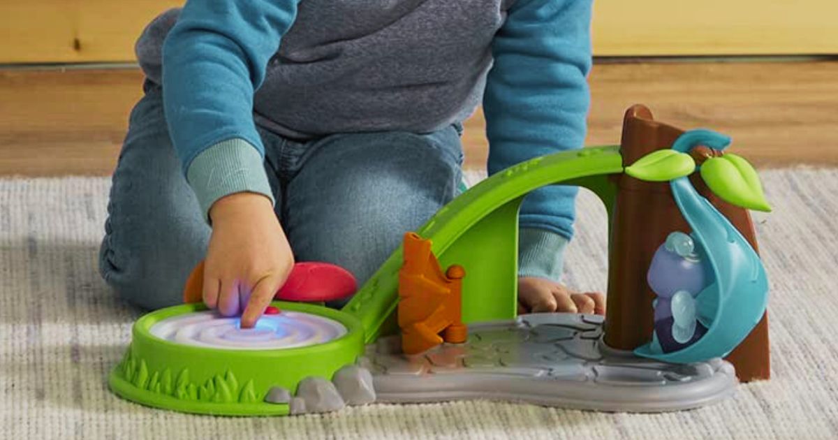 kid playing with a glowing bug toy