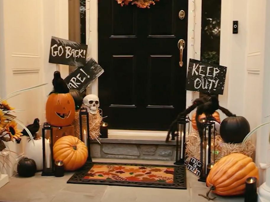 A doorstep with hallowen decor and slim remote control lanterns from QVC