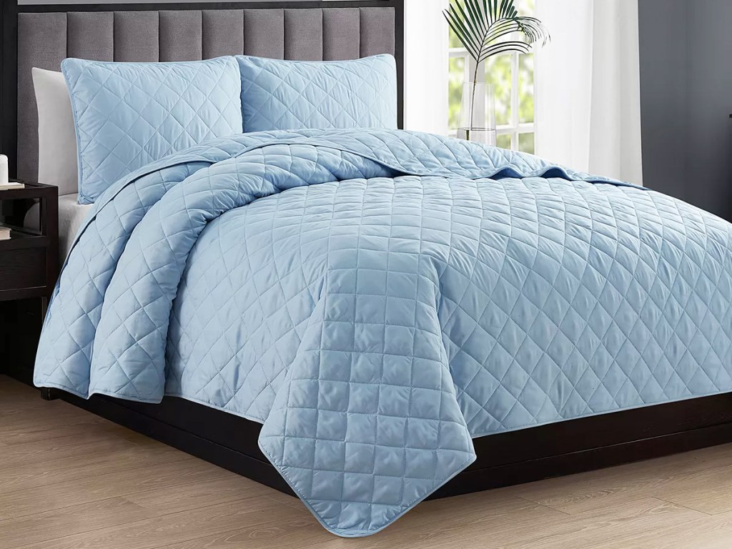 blue quilt set and matching shams on bed