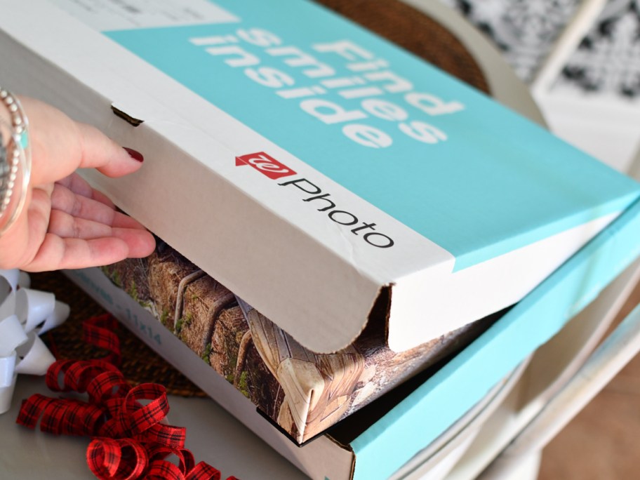 woman taking photo canvas out of box