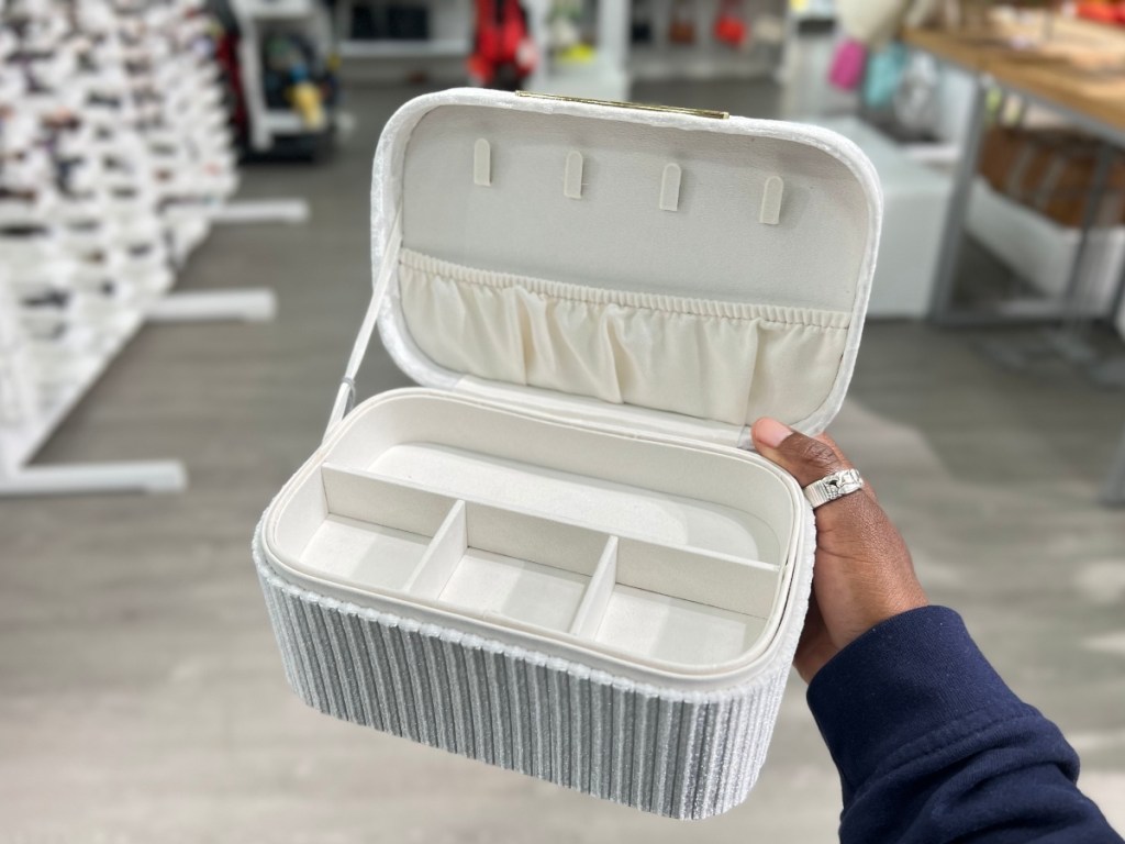 holding an open white jewlery box