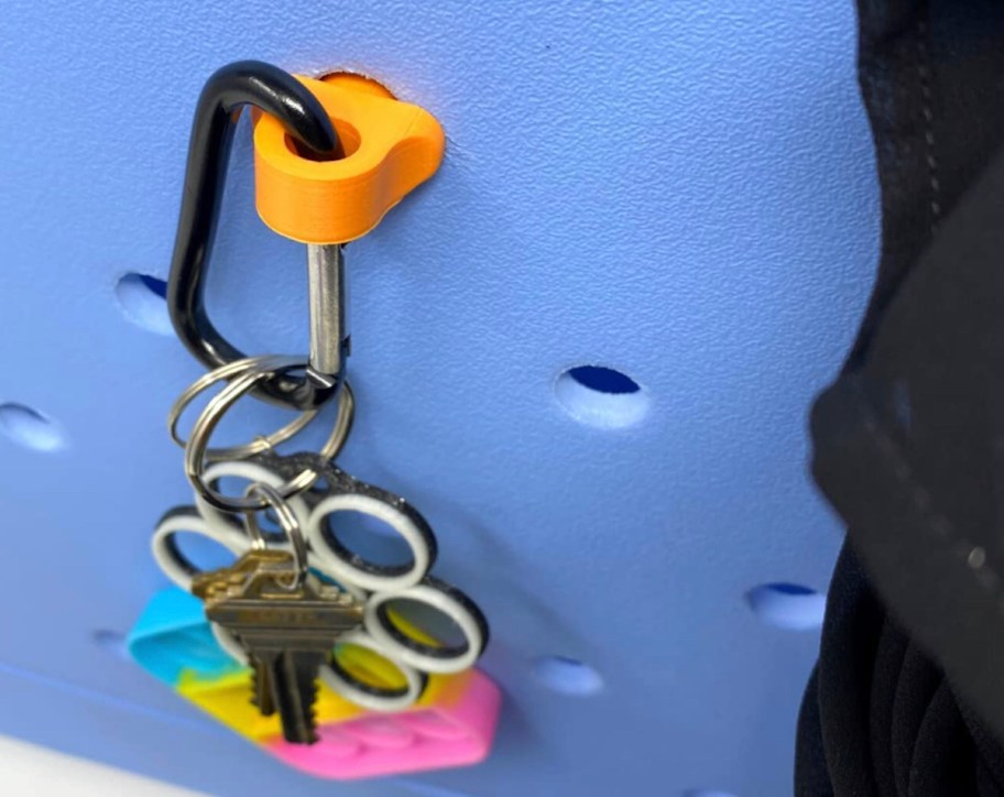 orange and black carabiner hook on waterproof bag