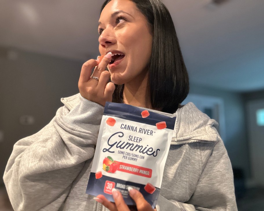 woman taking cbd gummy