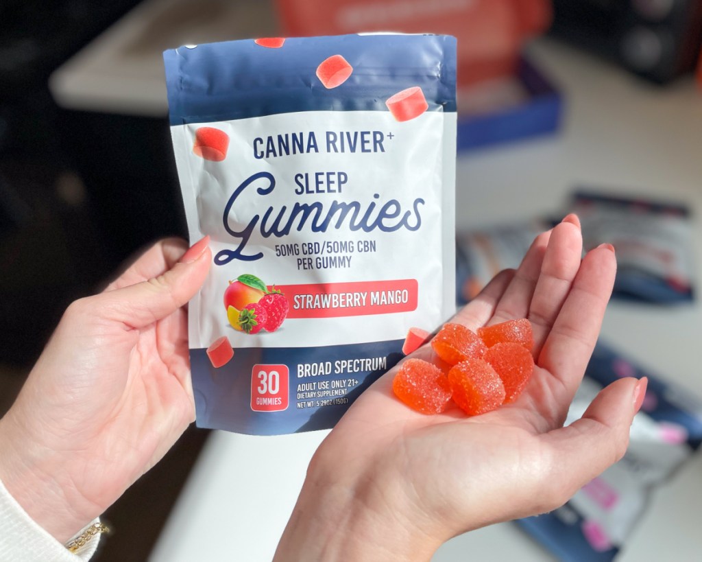 cbd gummies in hand next to bag