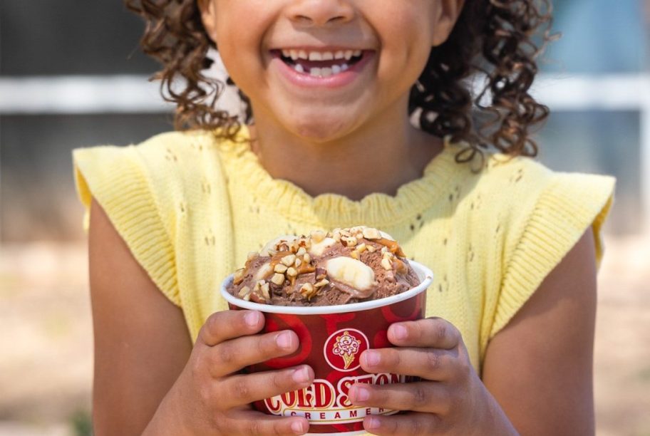 girl holding a cup of Coldstone ice cream