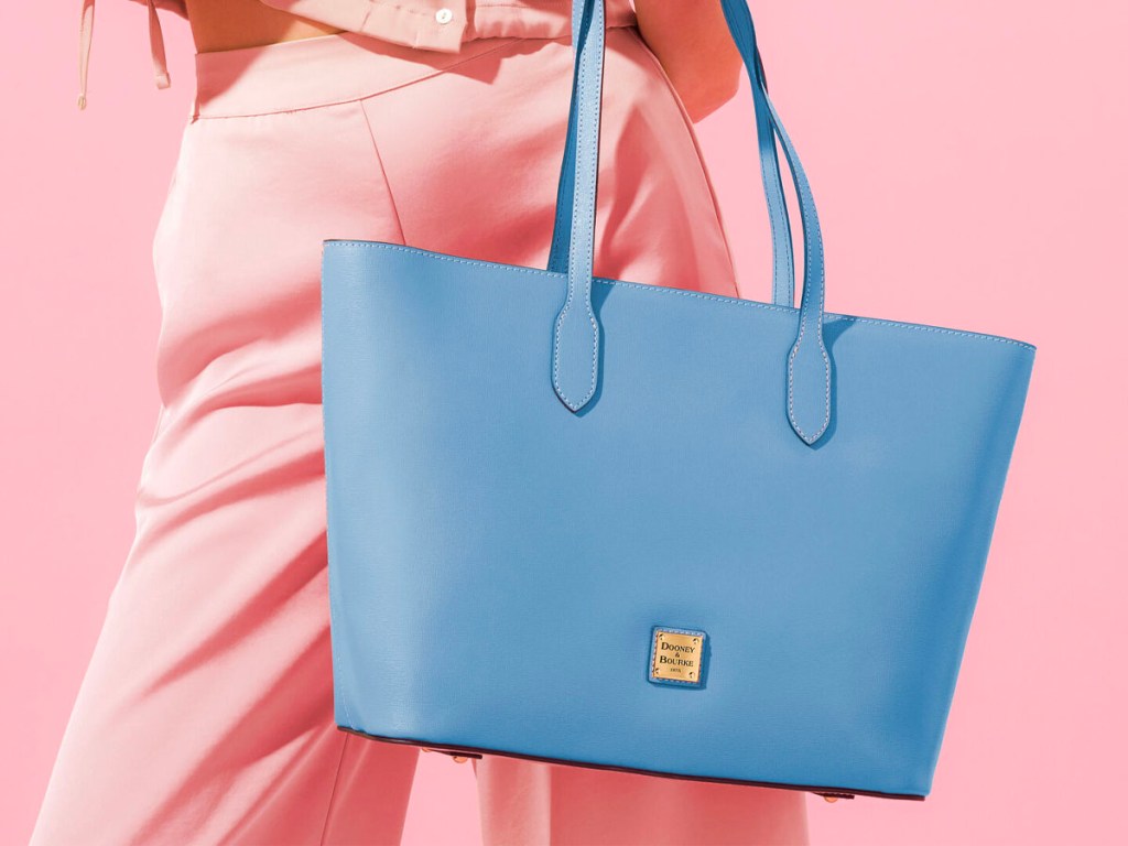 woman holding baby blue tote