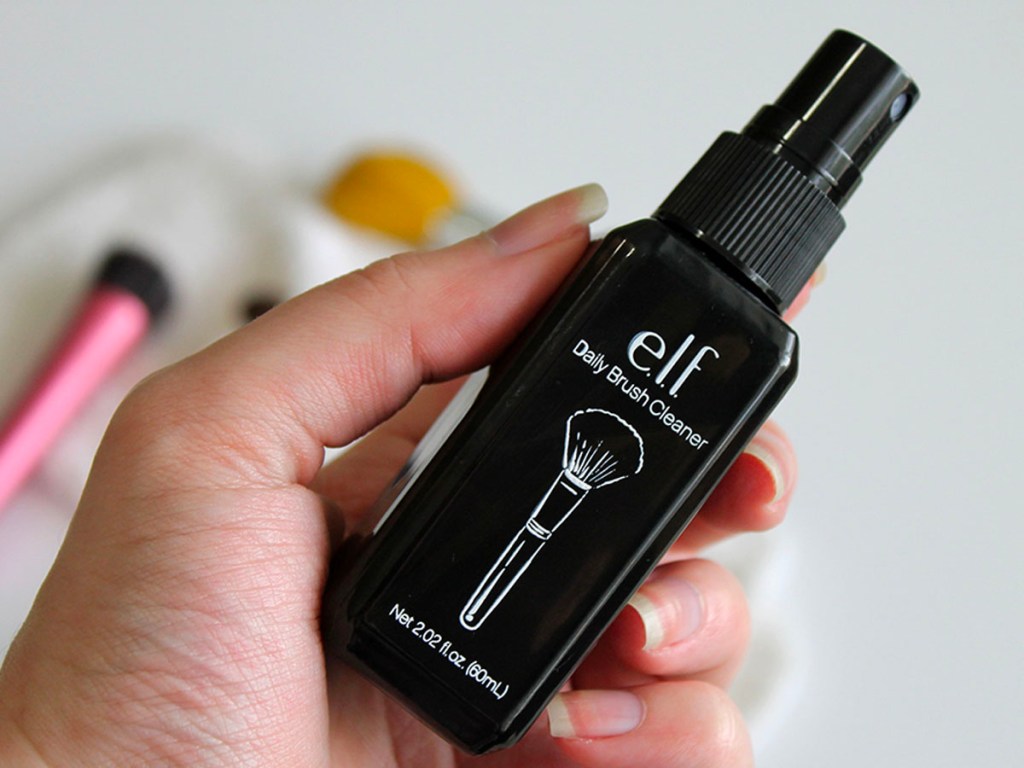 hand holding elf daily brush cleaner