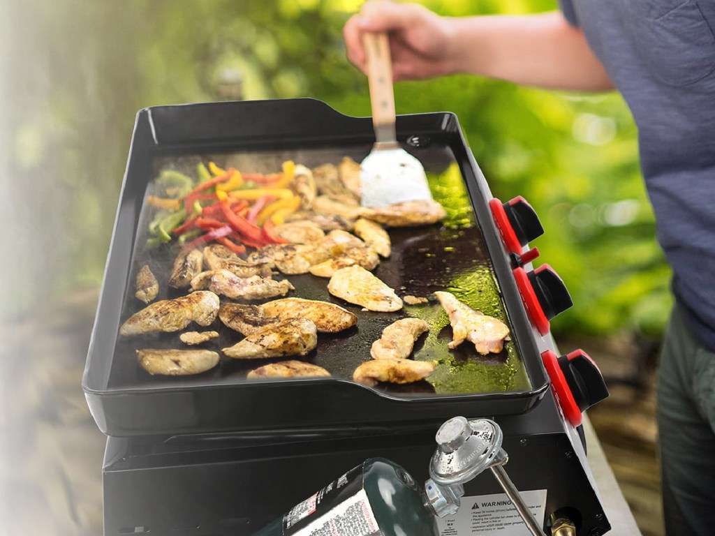 man cooking food on griddle