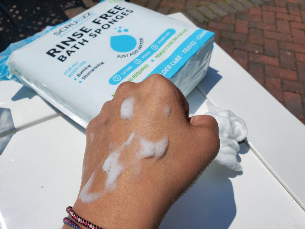 hand showing the suds from using a scrubzz rinse free bath sponge