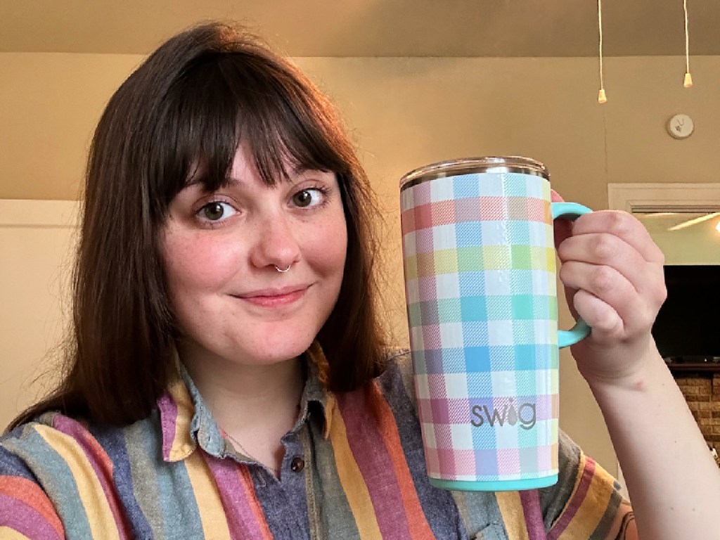 woman holding a swig tumbler