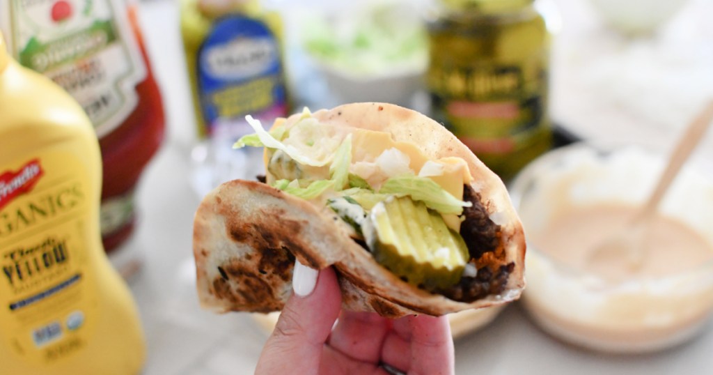 woman holding a copycat big mac smash burger taco