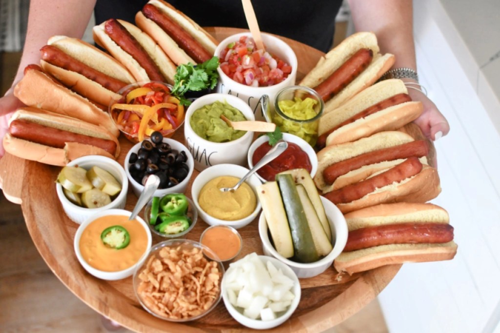 woman-holding-a-hot-dog-charcuterie-board