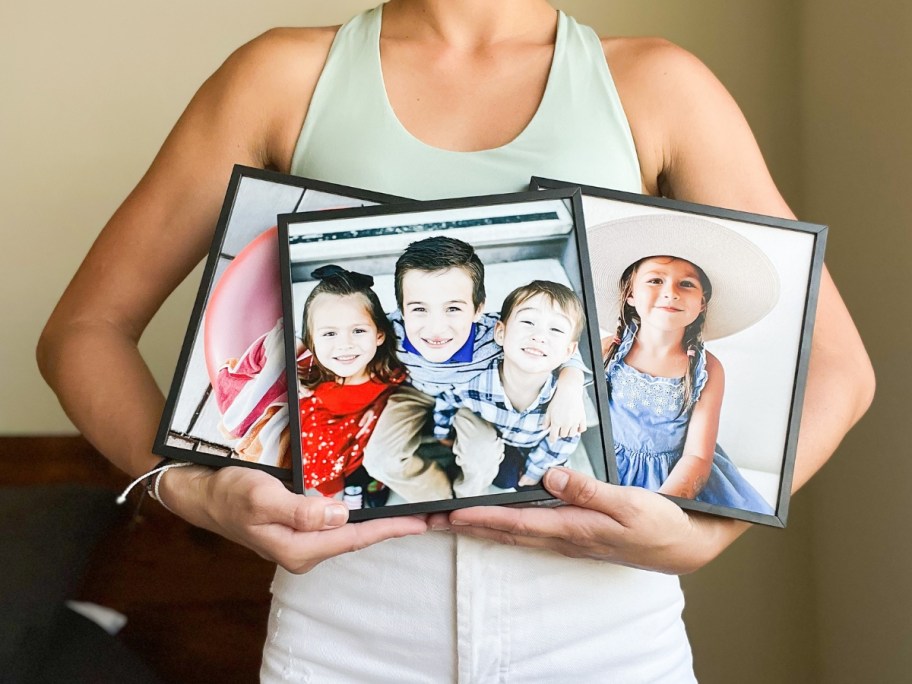 woman holding three tilepix prints