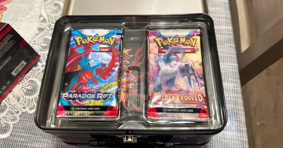 open metal tin with Pokemon cards