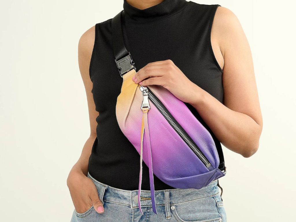 person wearing ombre belt bag across body