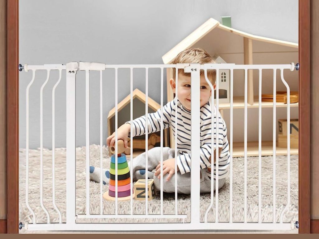 A baby behind a safety gate