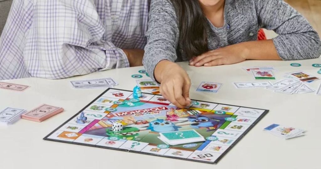 a mother and daughter playing Discover monopoly