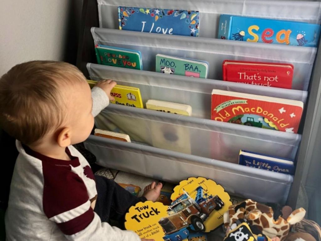 A child removing a book from a Humble Crew bookshelf