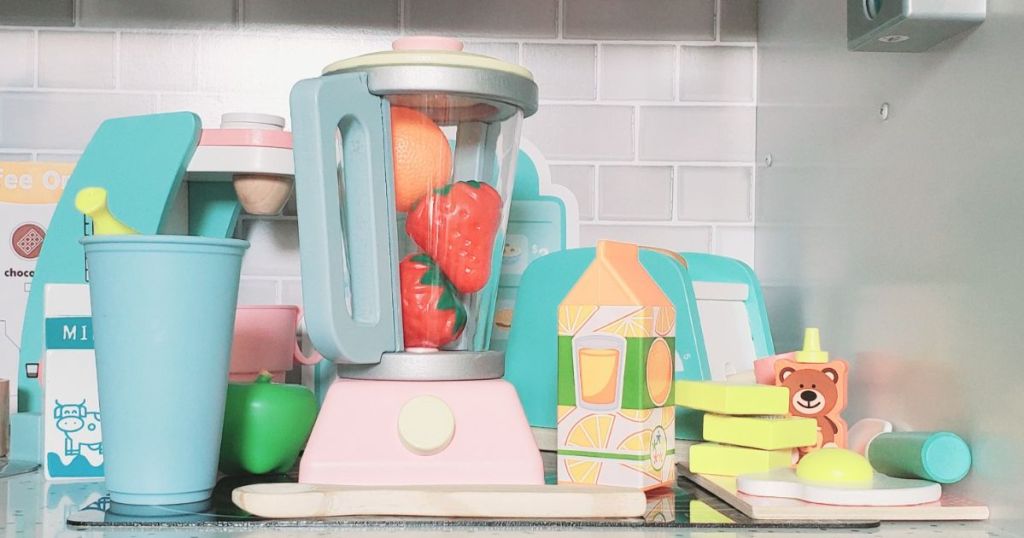 A child's wooden blender with plastic food