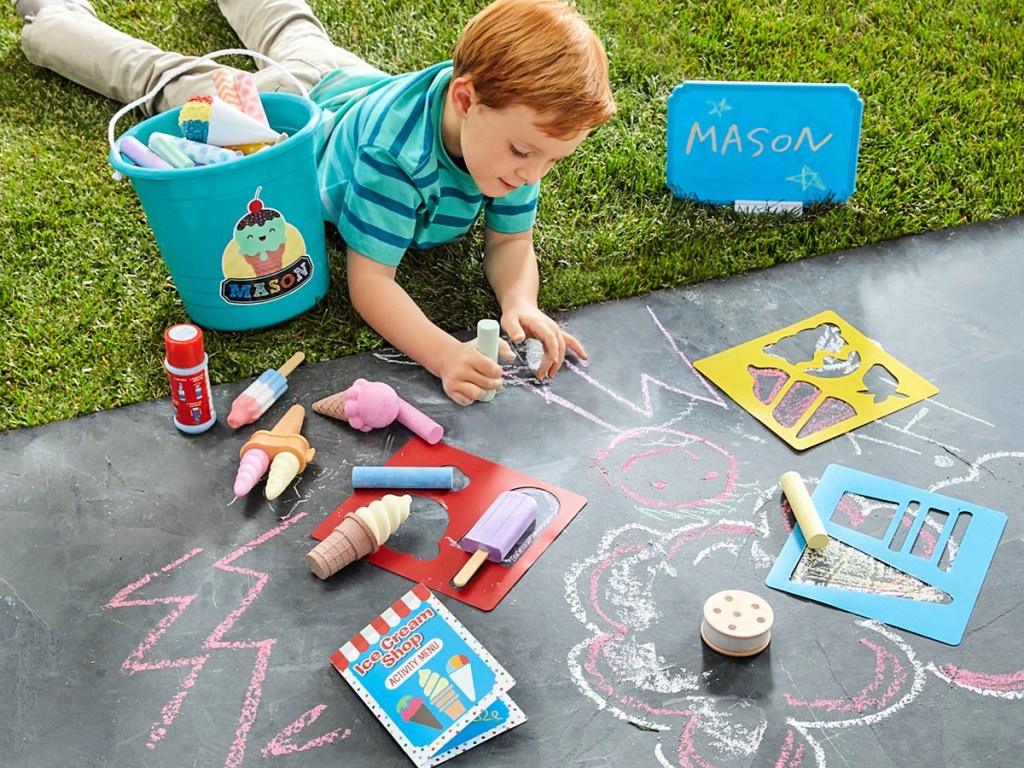 little boy playing with a Melissa & Doug Ice Cream Shop play set