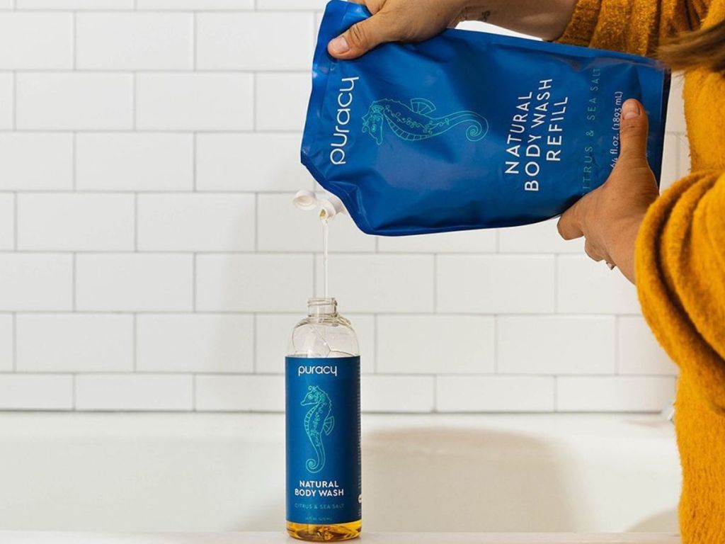 Woman pouring body wash into a bottle from a refill bag