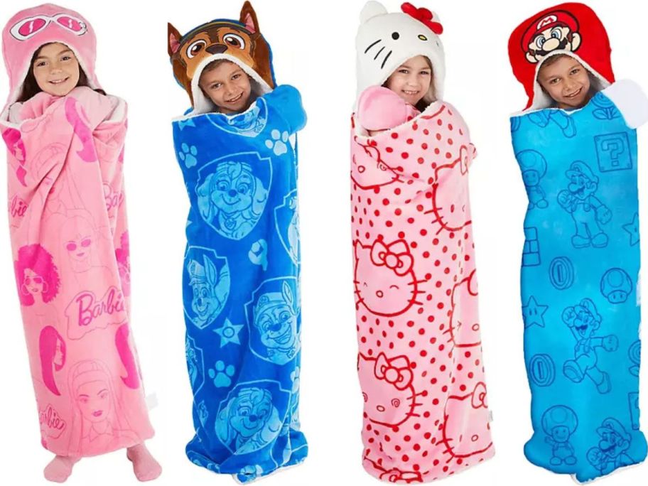 Stock images of 4 kids wearing Barbie, Paw Patrol, Hello Kitty and Super Mario hooded wearable blankets