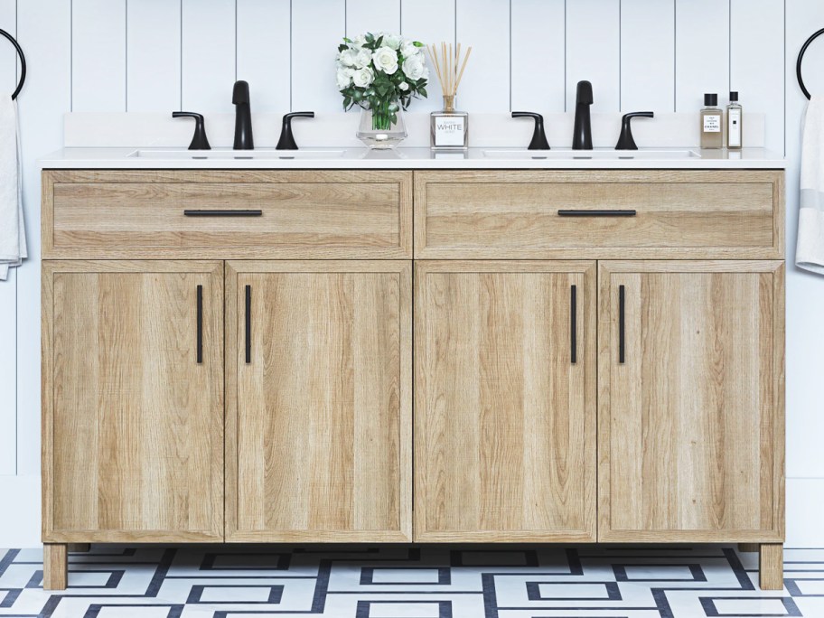 wood double vanity with white top and black fixtures