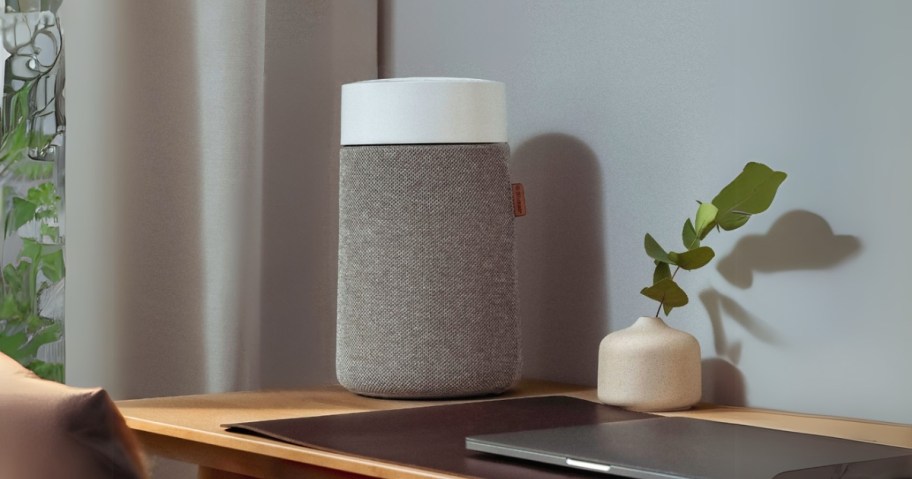 a small grey and white air purifier on a desk