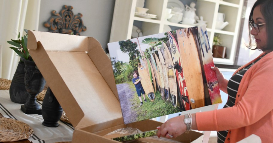 woman taking canvas out of box