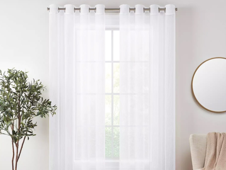 sheer white curtain panels over window