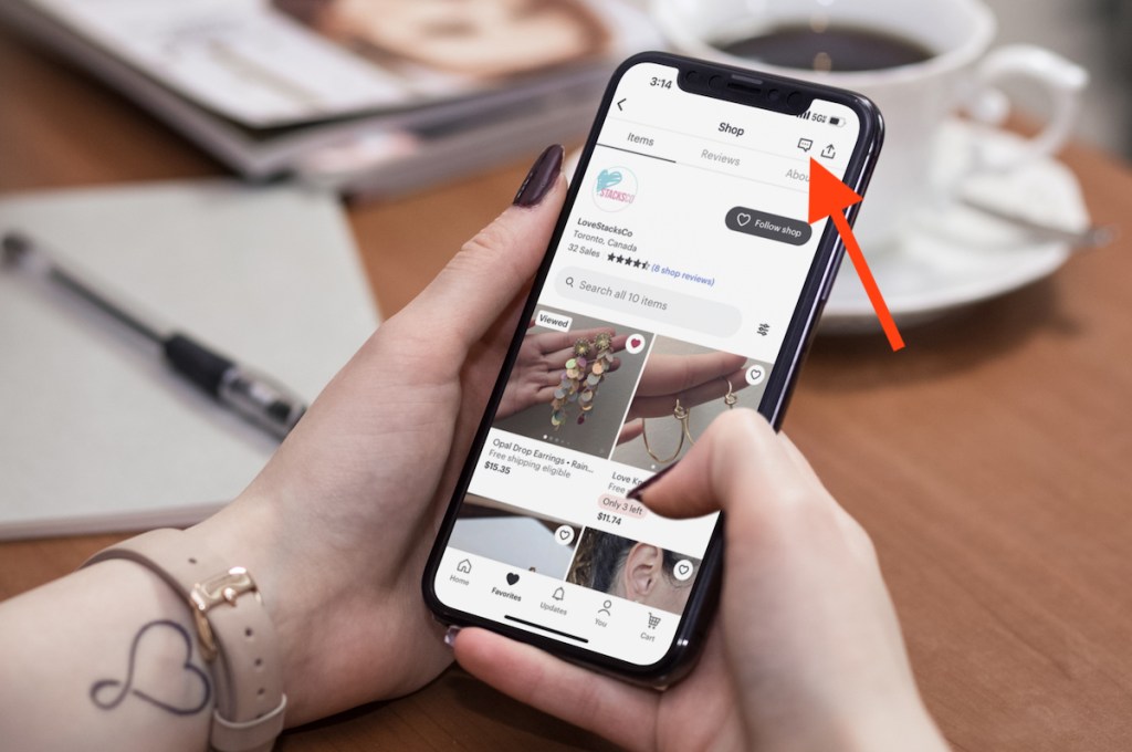 hands holding phone with etsy shop on screen and red arrow pointing to message button