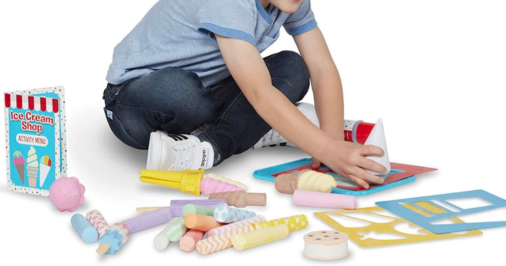 child playing with ice cream chalk set