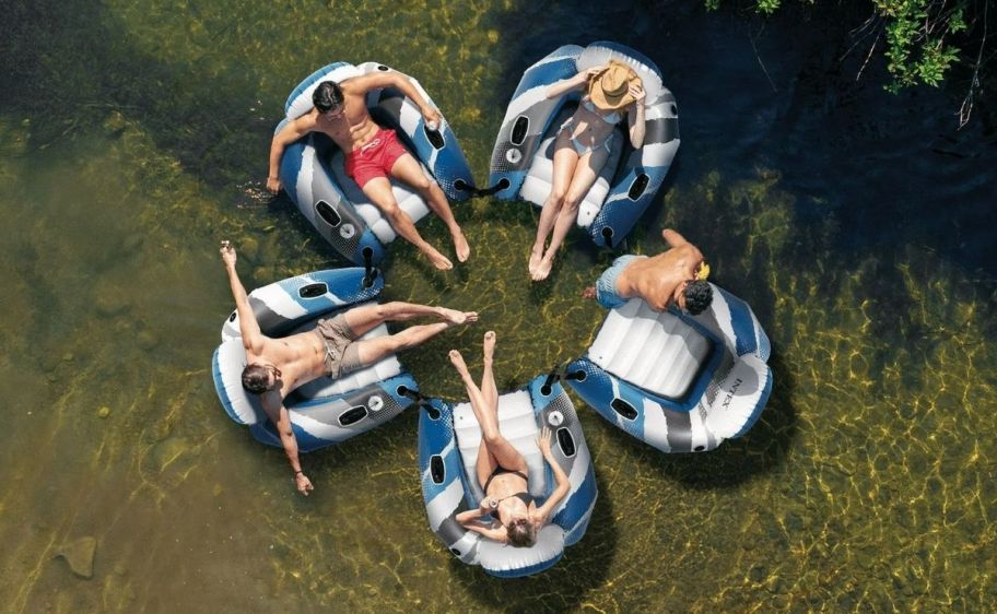 5 people in pool floats tethered togther in a circle