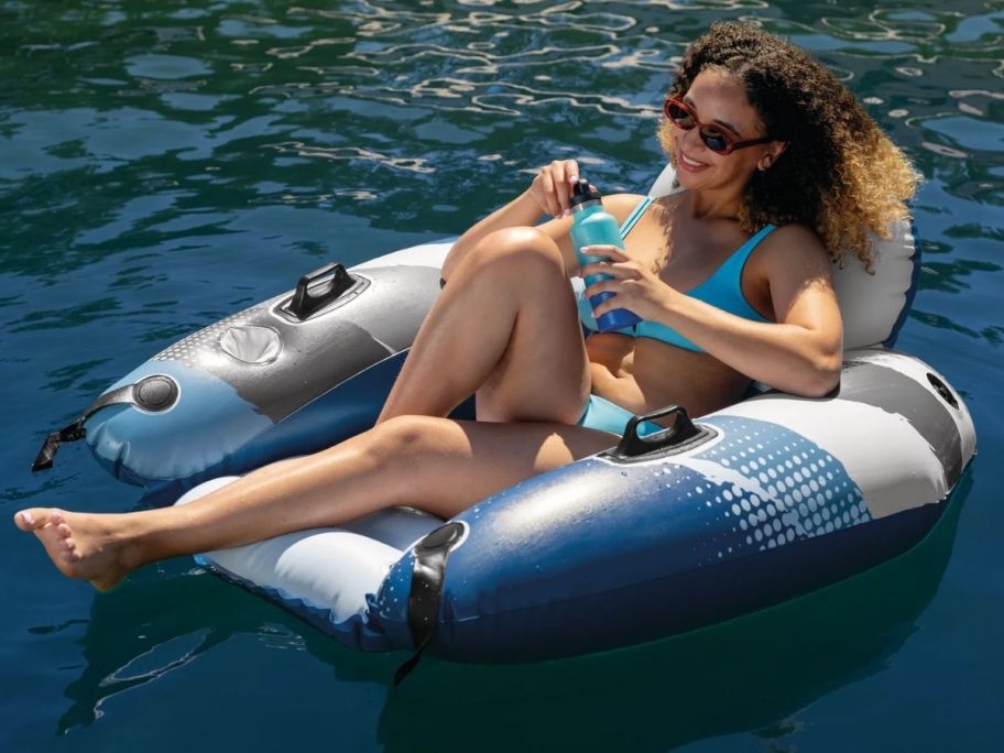a woman in a swimsuit on a chair style pool float