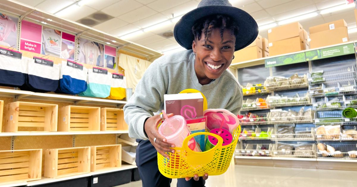 a woman holding a yellow jelly tote filled with small gifts 